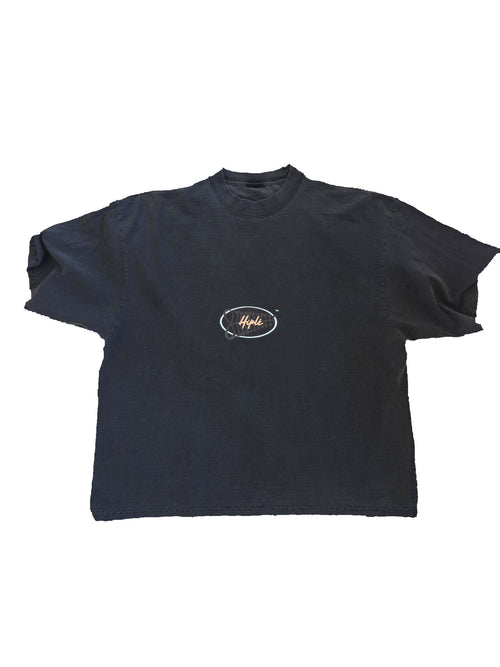 A garment dyed grey short-sleeve t-shirt with a small oval graphic on the center chest containing the word 'Hiplé' against a white background. By the brand Hiplé (Hiple)